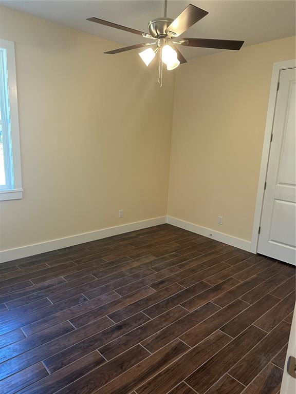 4011 Amber Road Valrico, FL 33594 - Photo 24 of 32 a view of a room with wooden floor and a ceiling fan
