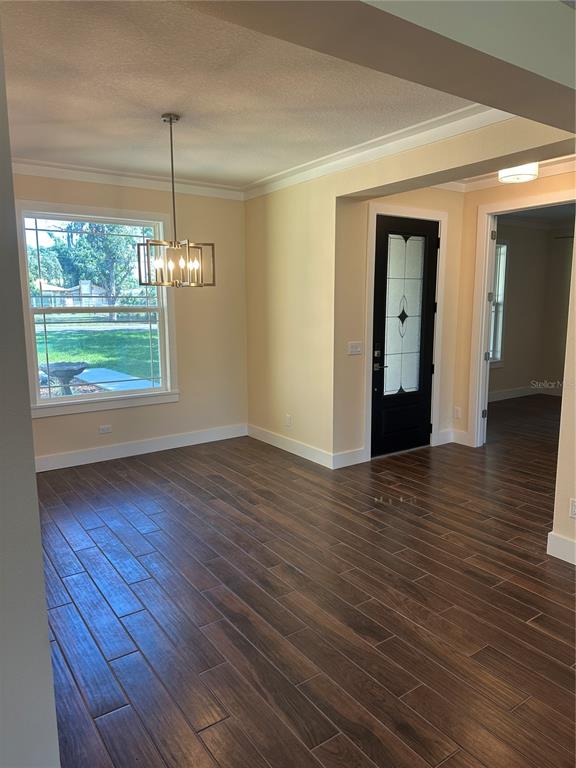 4011 Amber Road Valrico, FL 33594 - Photo 5 of 32 a view of an empty room with wooden floor and a window