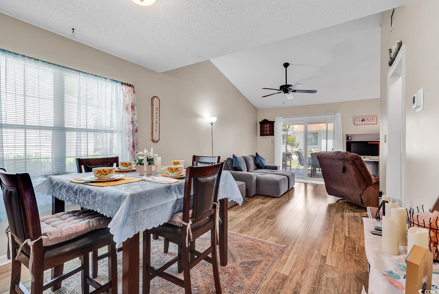 6628 Mallard View Point Myrtle Beach, SC 29588 - Photo 15 of 34 Dining room featuring a textured ceiling, ceiling fan, lofted ceiling, and light wood-style floors