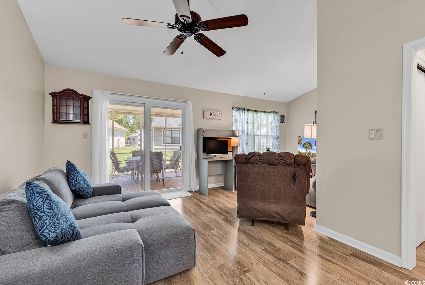 6628 Mallard View Point Myrtle Beach, SC 29588 - Photo 17 of 34 Living area featuring ceiling fan, a healthy amount of sunlight, lofted ceiling, and light wood-style floors