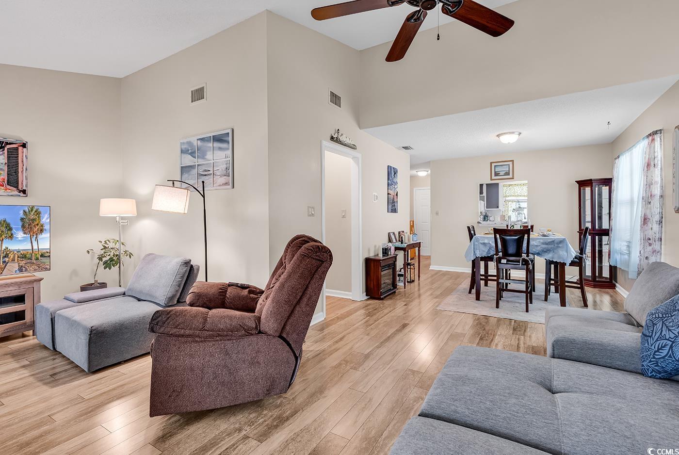 6628 Mallard View Point Myrtle Beach, SC 29588 - Photo 19 of 34 Living area featuring ceiling fan, visible vents, and light wood-style floors