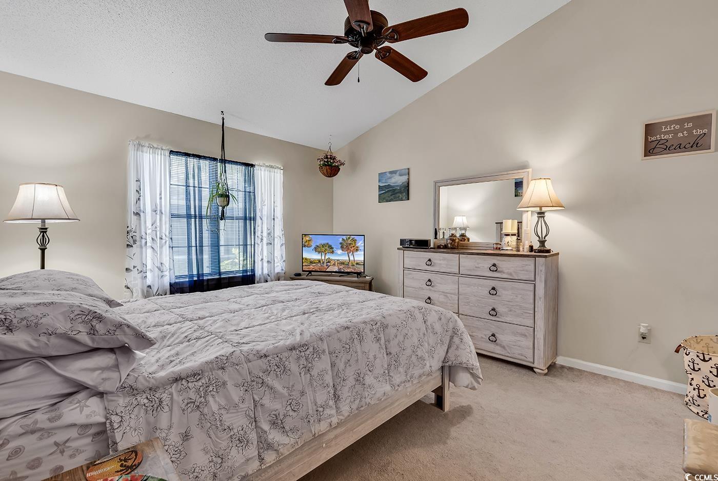 6628 Mallard View Point Myrtle Beach, SC 29588 - Photo 2 of 34 Bedroom featuring baseboards, a ceiling fan, vaulted ceiling, and light colored carpet