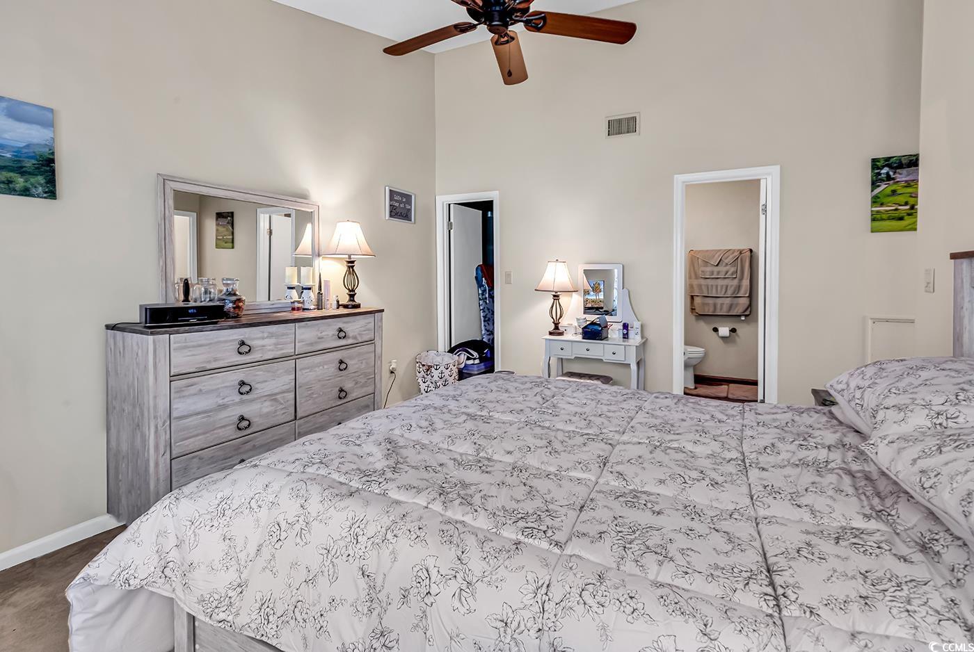 6628 Mallard View Point Myrtle Beach, SC 29588 - Photo 3 of 34 Bedroom with high vaulted ceiling, visible vents, baseboards, and ensuite bath