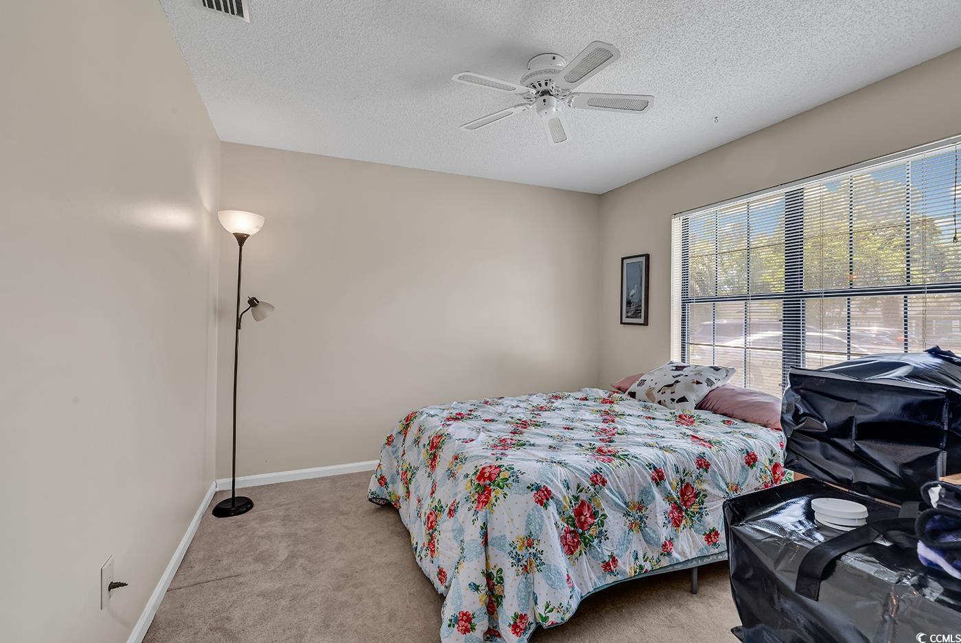 6628 Mallard View Point Myrtle Beach, SC 29588 - Photo 6 of 34 Bedroom with baseboards, ceiling fan, carpet, and a textured ceiling