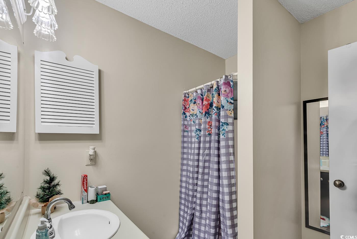 6628 Mallard View Point Myrtle Beach, SC 29588 - Photo 9 of 34 Full bath featuring vanity, a textured ceiling, and a shower with curtain