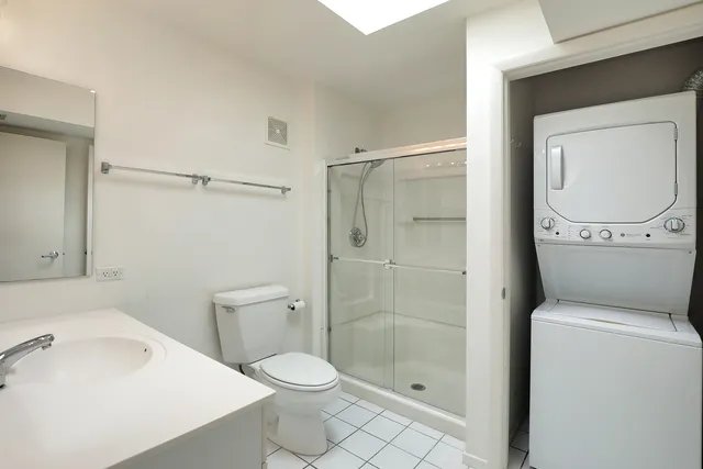 a bathroom with a toilet a sink and shower
