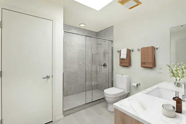 a bathroom with a sink toilet and shower