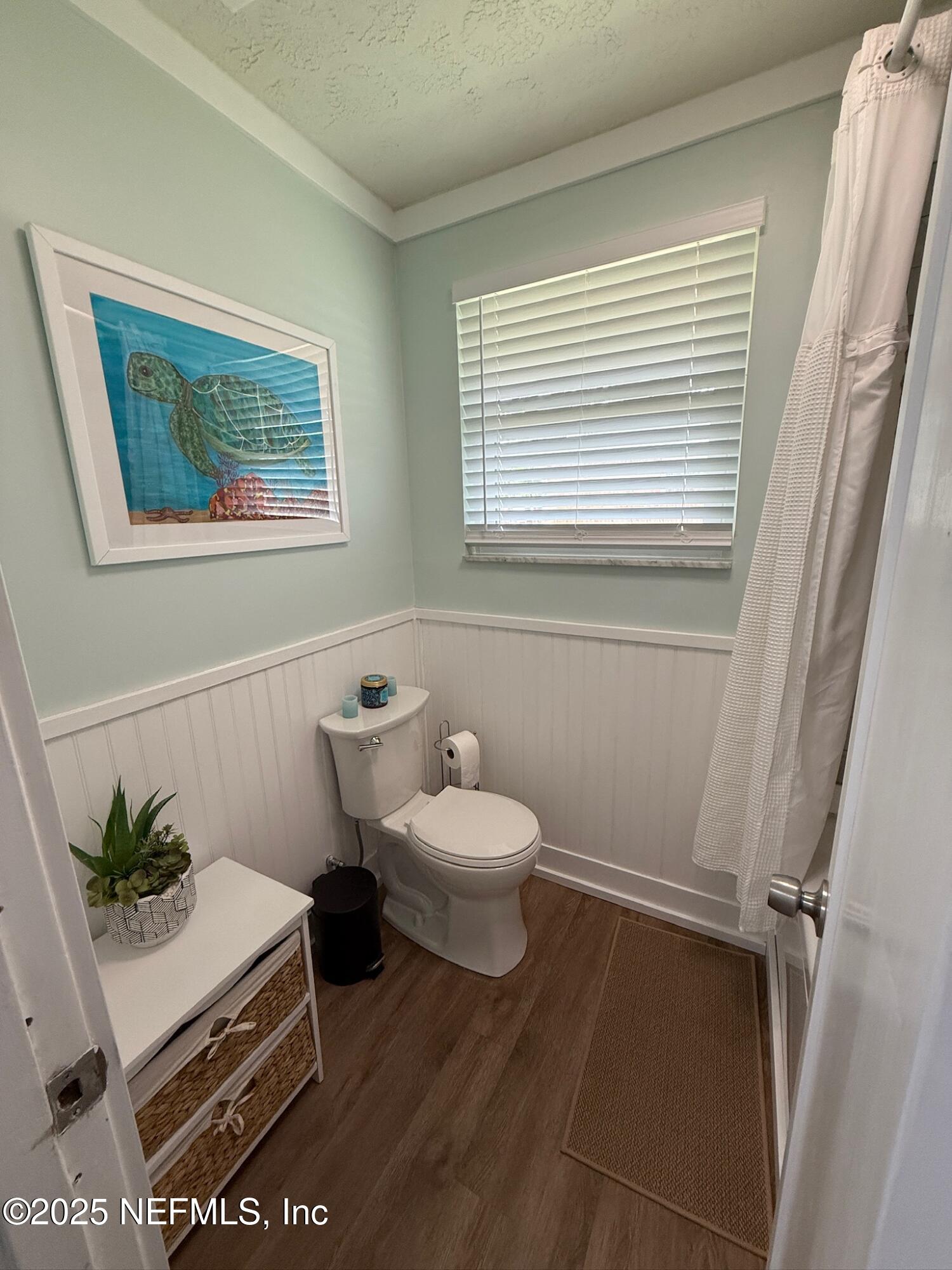 716 Oak Street Neptune Beach, FL 32266 - Photo 14 of 23 a bathroom with a toilet a sink and a mirror