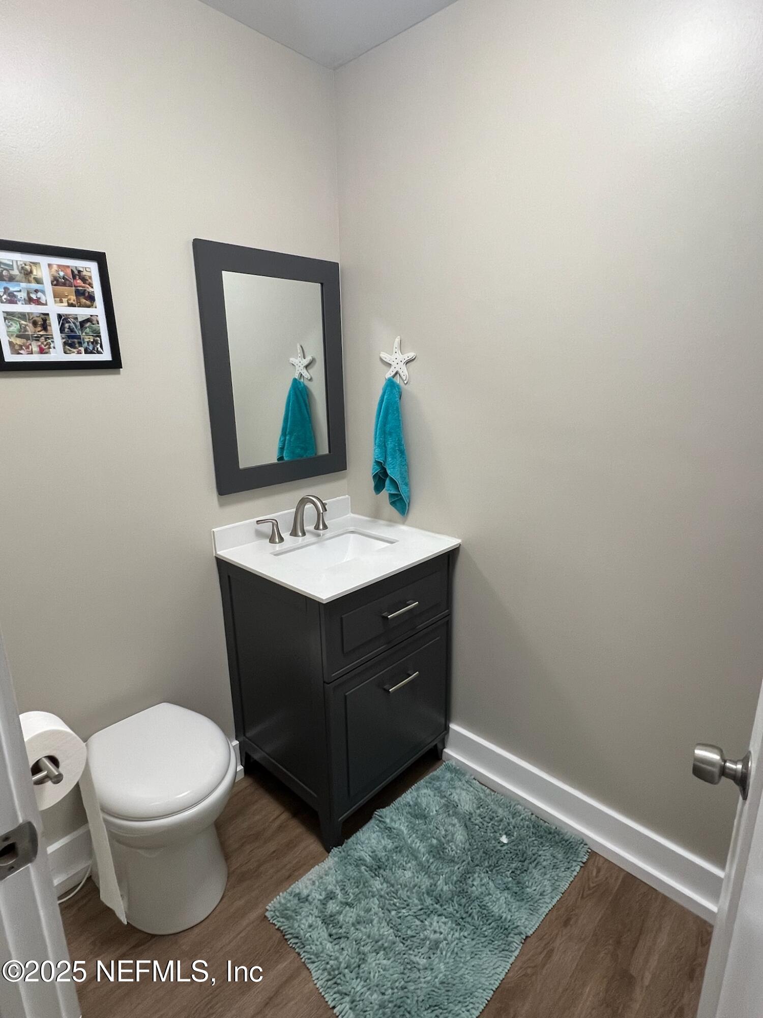 716 Oak Street Neptune Beach, FL 32266 - Photo 20 of 23 a bathroom with a toilet sink and mirror