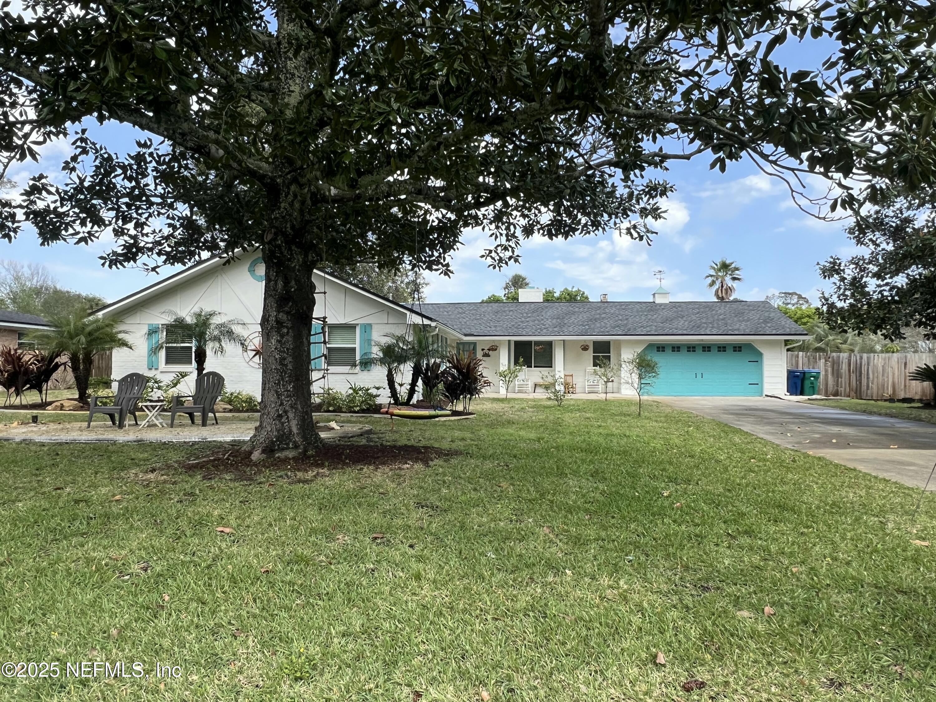 716 Oak Street Neptune Beach, FL 32266 - Photo 2 of 23 a front view of a house with a garden