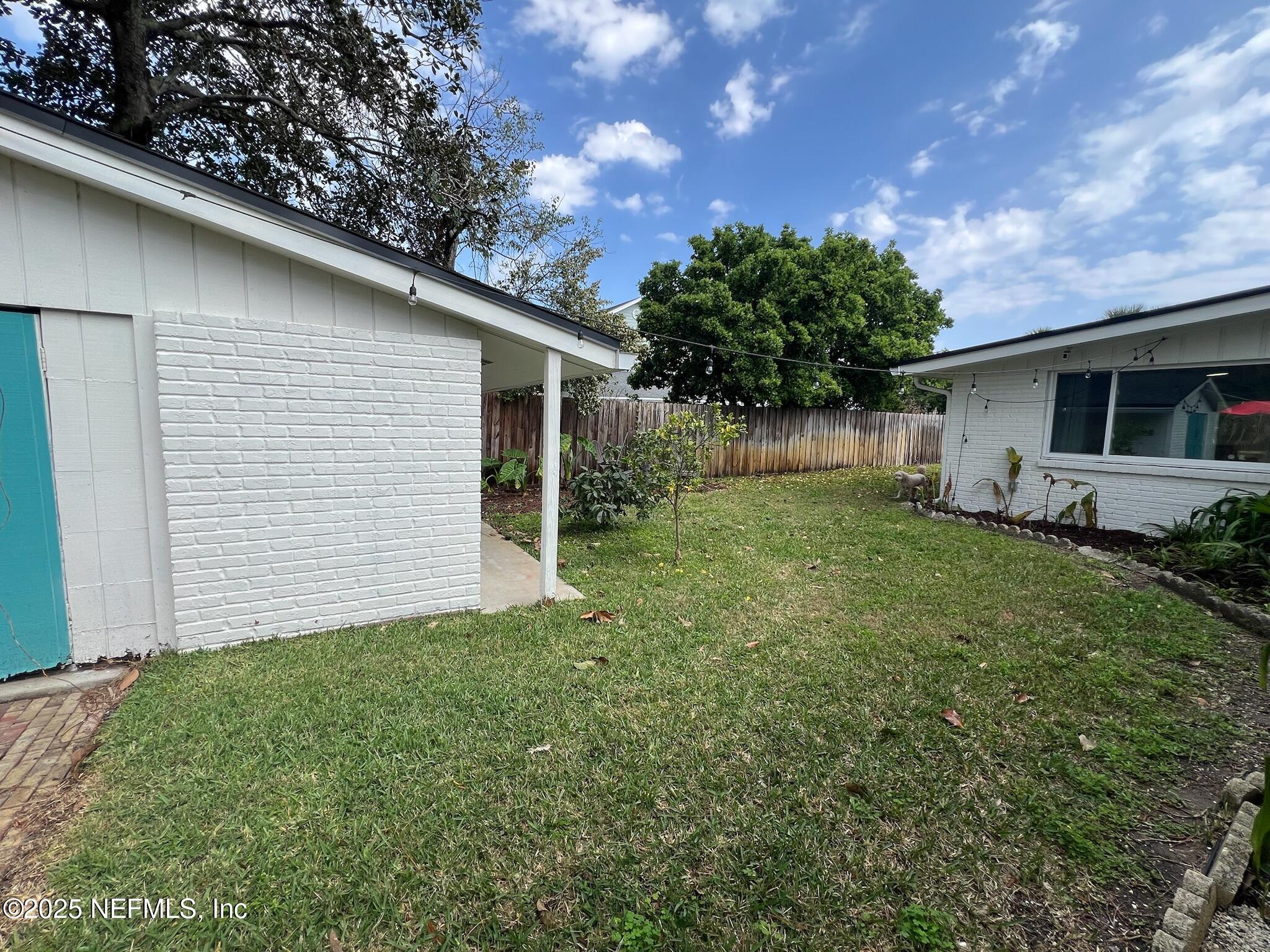 716 Oak Street Neptune Beach, FL 32266 - Photo 21 of 23 a backyard of a house with plants and tree
