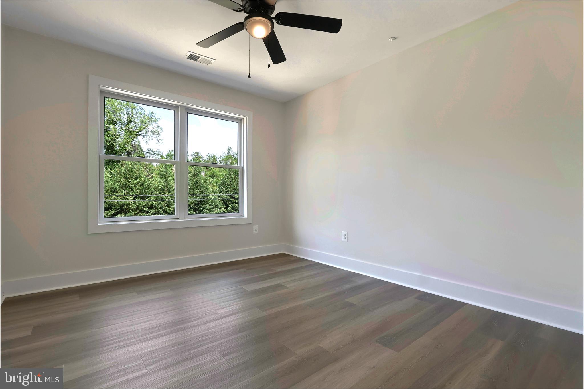23131 Meadow Road Bushwood, MD 20618 - Photo 25 of 42 an empty room with wooden floor fan and windows