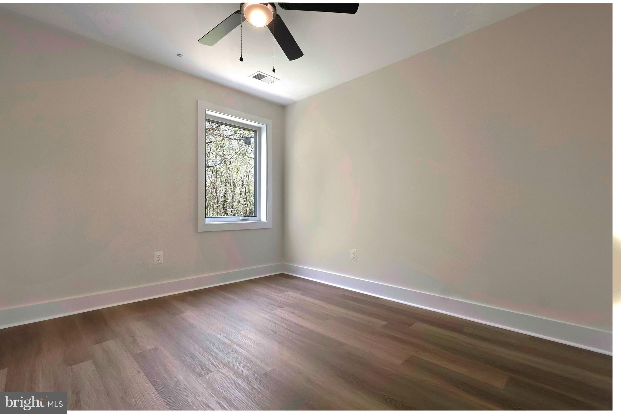 23131 Meadow Road Bushwood, MD 20618 - Photo 26 of 42 a view of an empty room with wooden floor and window