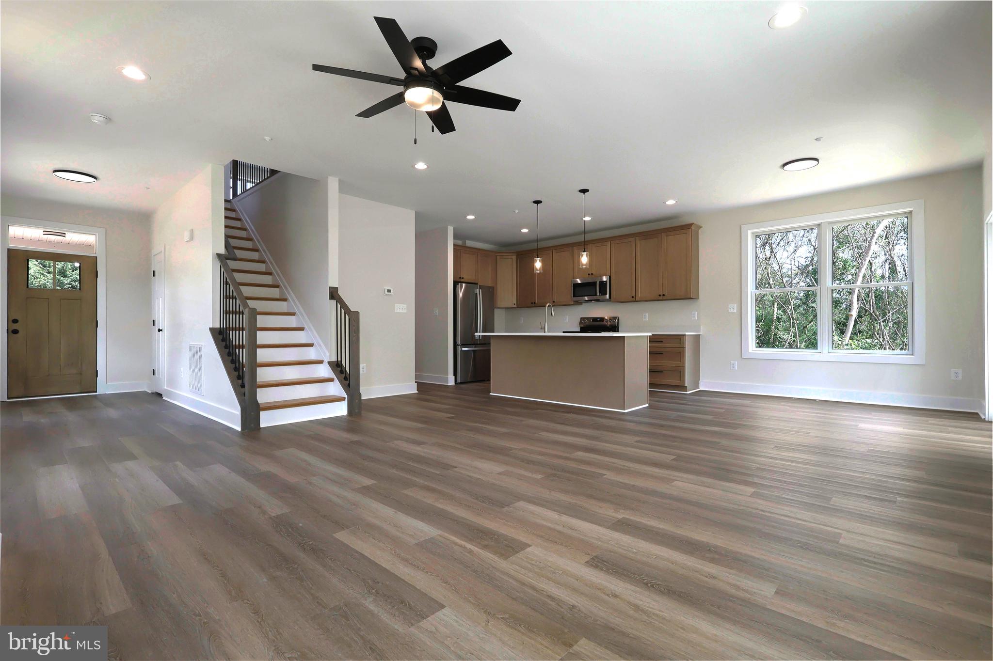 23131 Meadow Road Bushwood, MD 20618 - Photo 31 of 42 an empty room with wooden floor a ceiling fan and windows