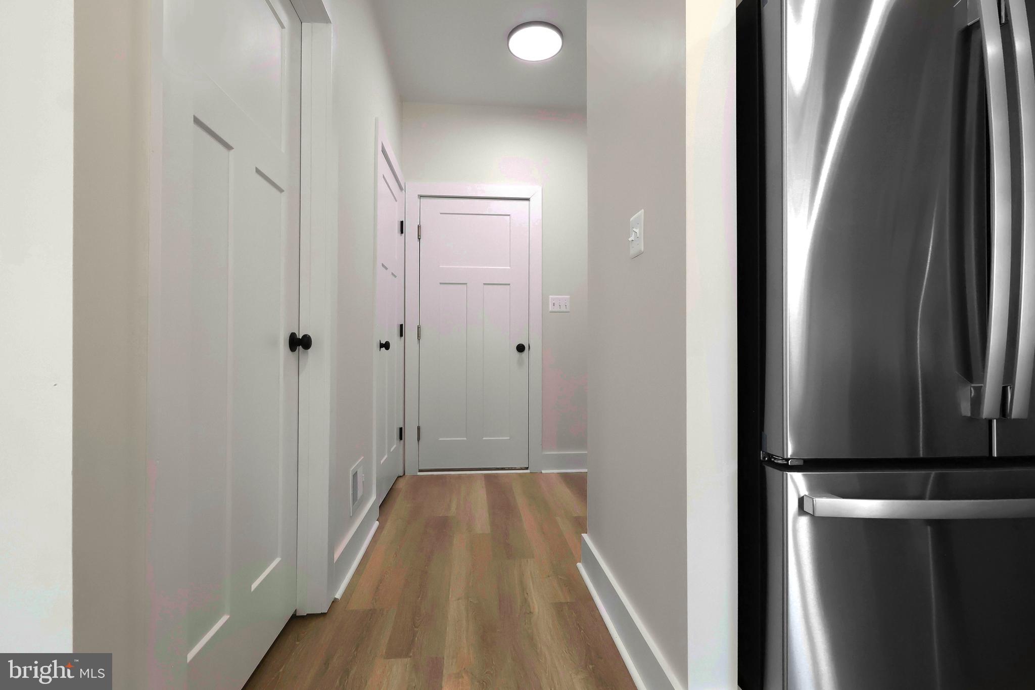 23131 Meadow Road Bushwood, MD 20618 - Photo 36 of 42 a view of a hallway with wooden floor