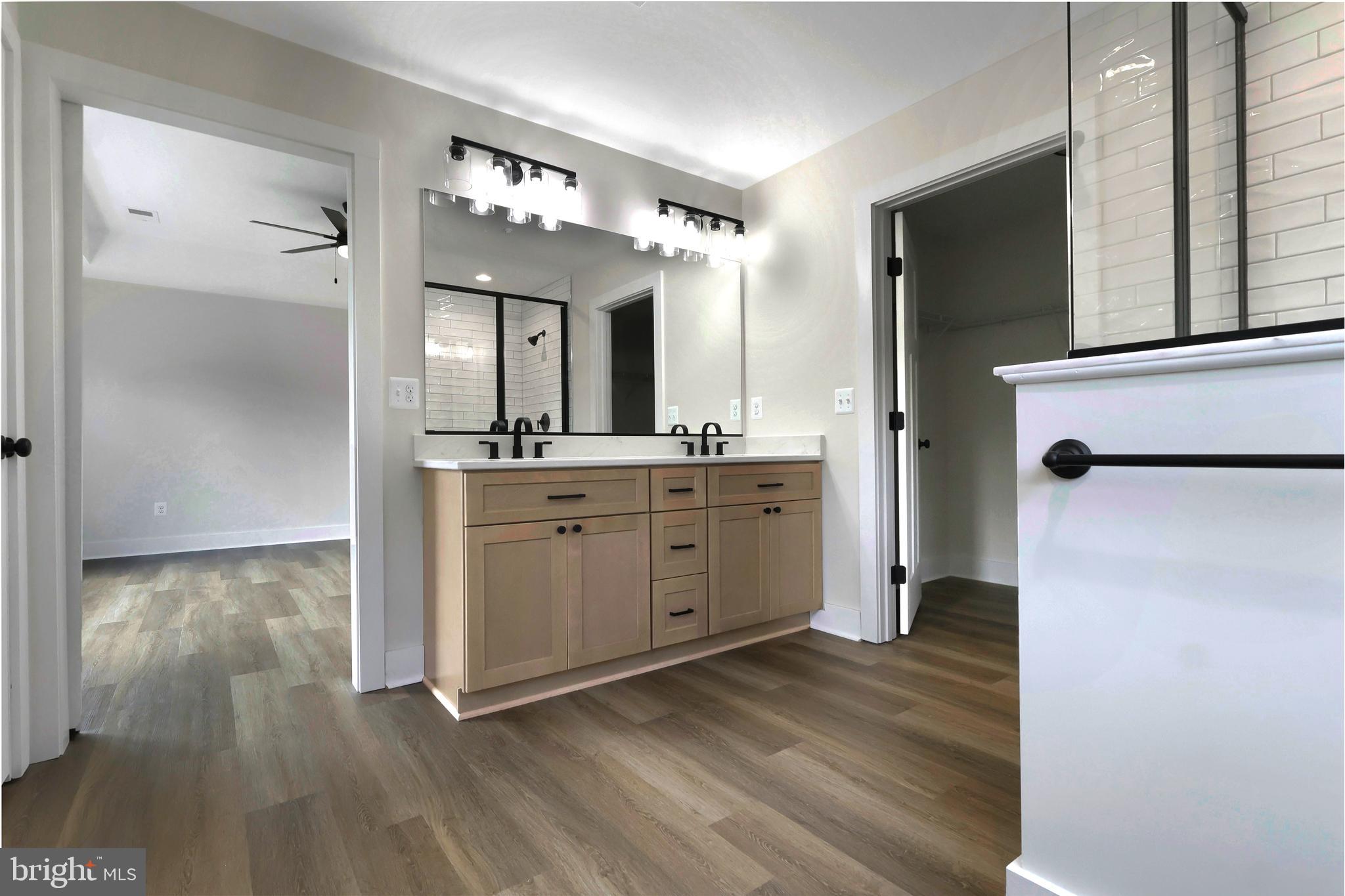 23131 Meadow Road Bushwood, MD 20618 - Photo 9 of 42 a spacious bathroom with a double vanity sink and a mirror