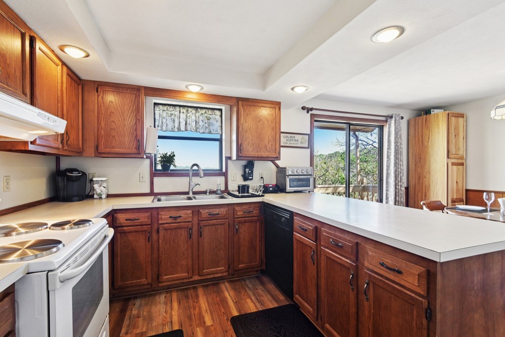 115 South Codrington Kerrville, TX 78028 - Photo 11 of 33 a kitchen with a sink stove and cabinets