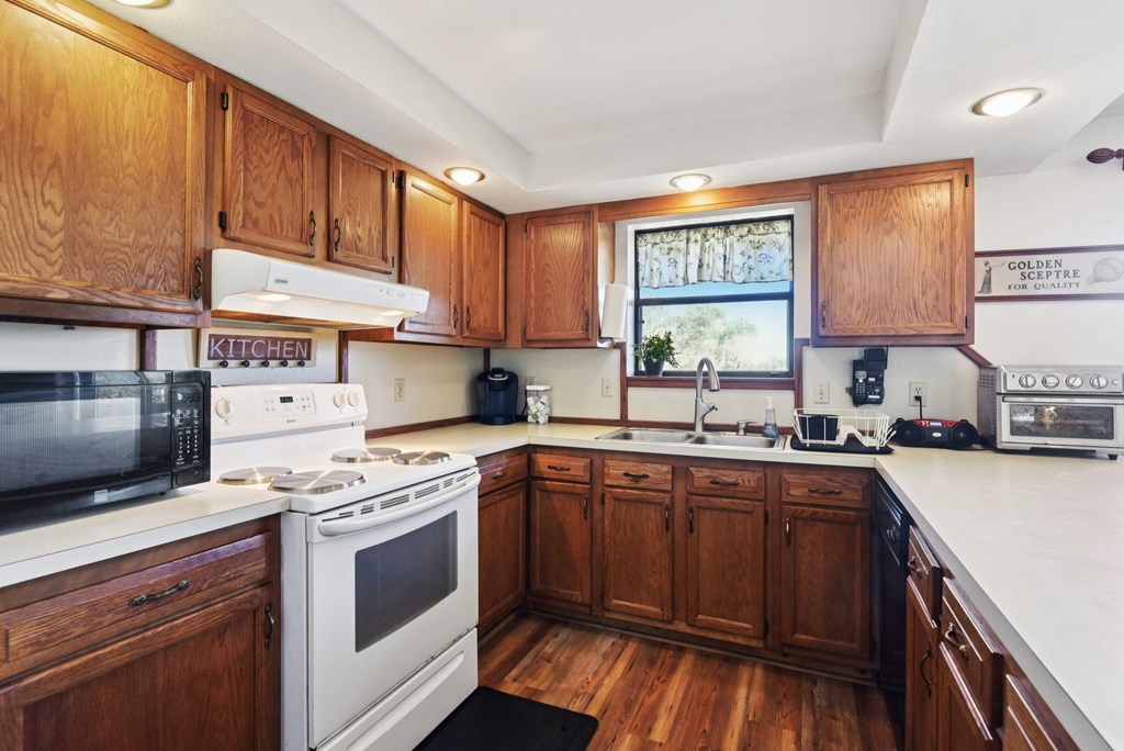 115 South Codrington Kerrville, TX 78028 - Photo 12 of 33 a kitchen with a stove a sink and a microwave