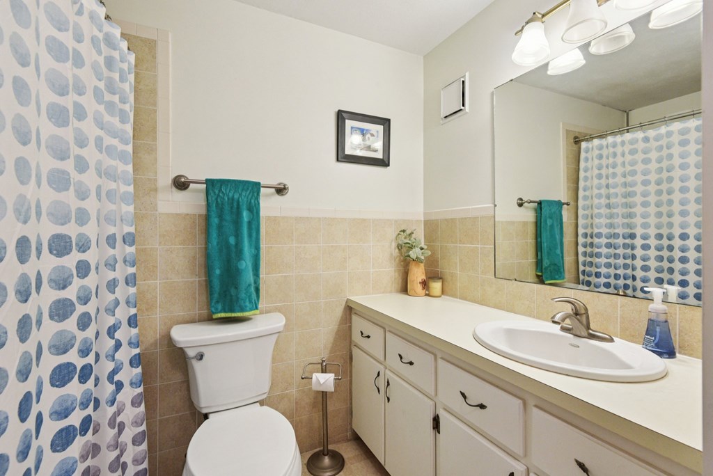 115 South Codrington Kerrville, TX 78028 - Photo 15 of 33 a bathroom with a granite countertop toilet a sink and a mirror