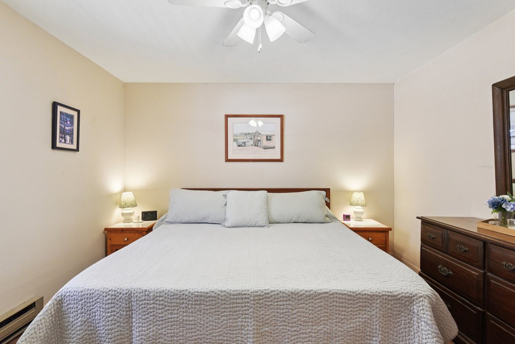 115 South Codrington Kerrville, TX 78028 - Photo 19 of 33 a bedroom with a bed and a chandelier