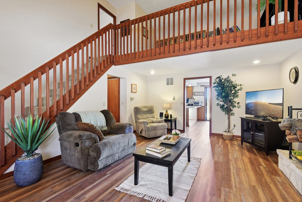115 South Codrington Kerrville, TX 78028 - Photo 5 of 33 a living room with furniture stairs and a potted plant