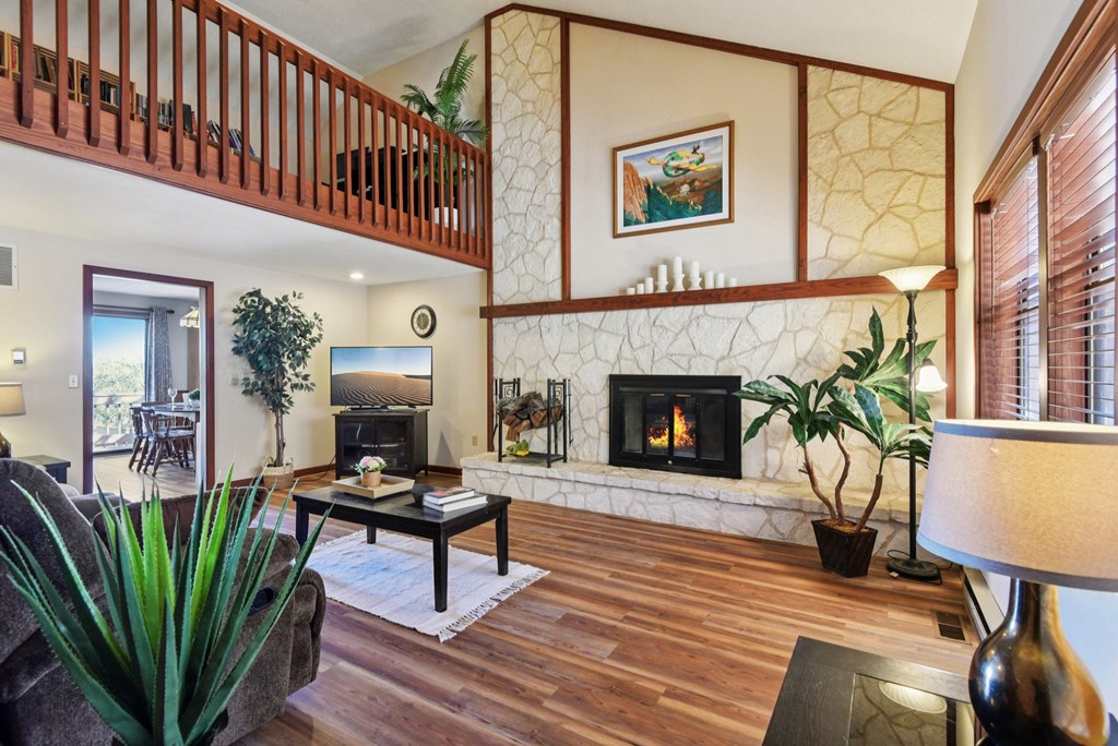 115 South Codrington Kerrville, TX 78028 - Photo 6 of 33 a living room with furniture a fireplace and a floor to ceiling window