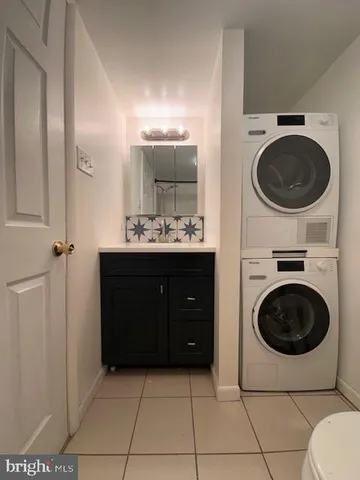 a spacious bathroom with a toilet a sink and mirror