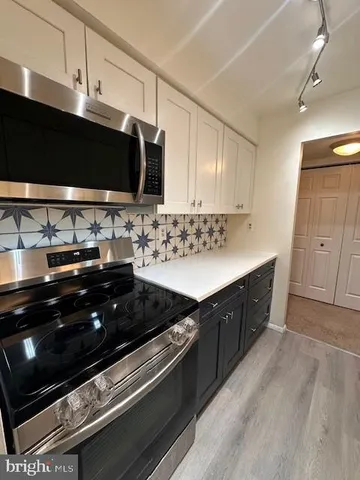 a kitchen with a sink stove and microwave