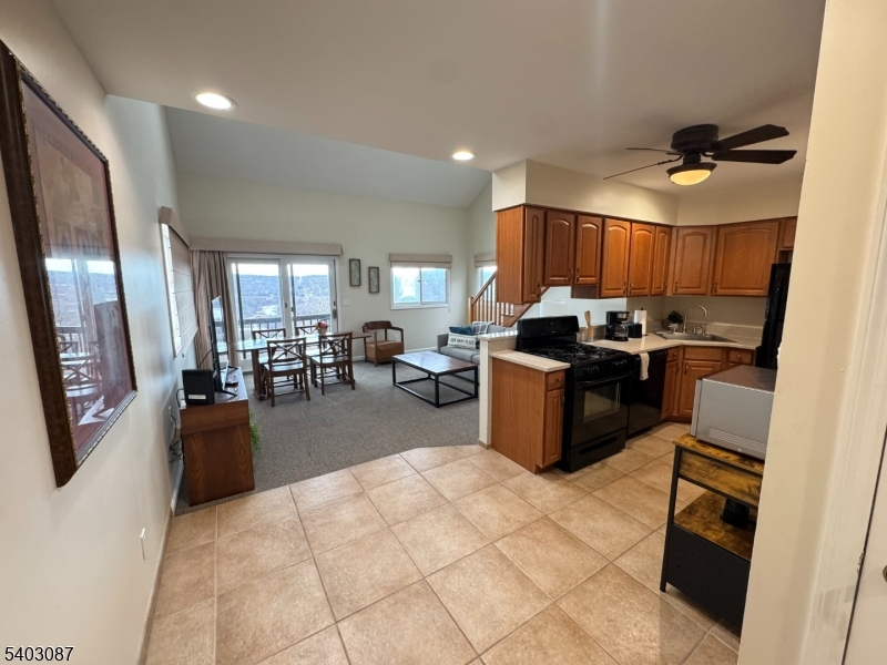 3 Telemark Drive, Unit 12 Vernon, NJ 07462 - Photo 2 of 14 a kitchen with stainless steel appliances granite countertop a stove top oven a sink a dining table and chairs
