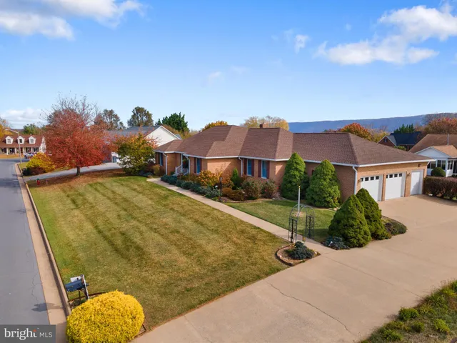 a view of a house with a swimming pool and a yard
