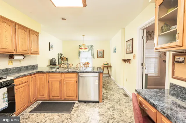 a large bathroom with granite countertop a sink a counter top space and cabinets