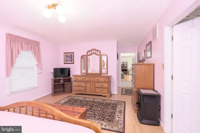 a bedroom with a bed and a television