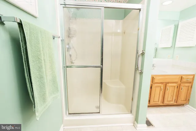 a bathroom with a glass shower door