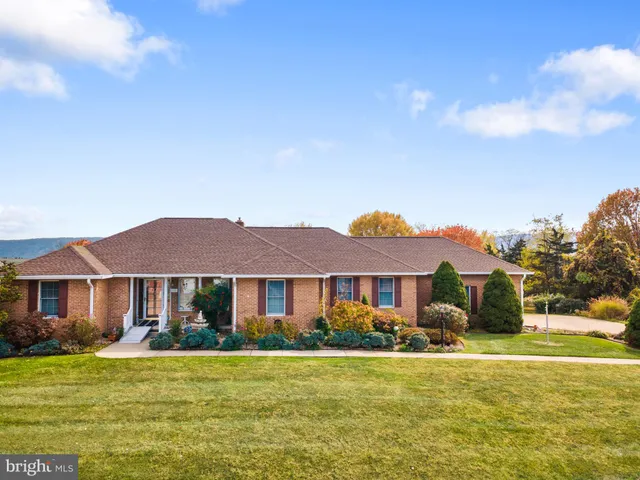 a front view of a house with a yard table and chairs