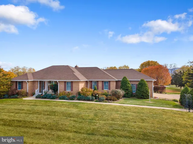 a front view of a house with a big yard