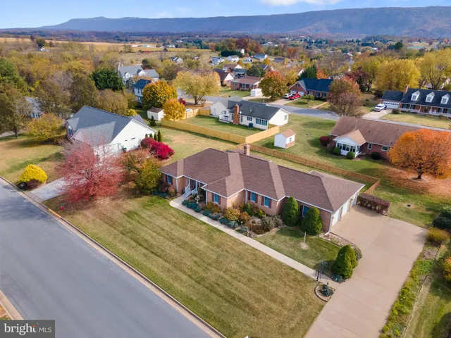 an aerial view of a houses with a swimming pool