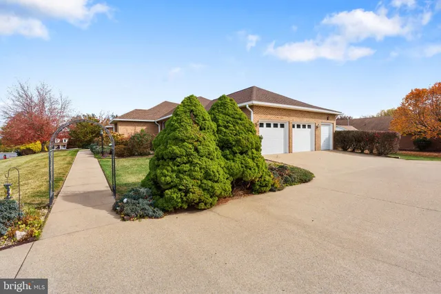 a view of a house with a yard and potted plants