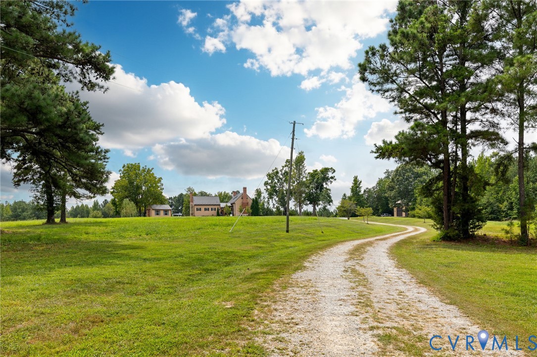 2284 Wallace's Bridge Road Lunenburg, VA 23952 - Photo 77 of 89 Expansive green lawn with mature trees and a windi