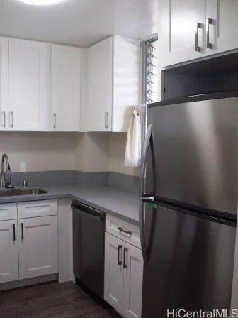 a kitchen with a sink and refrigerator