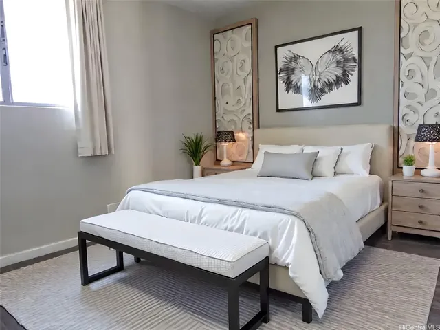 a bedroom with a bed and a painting on the wall