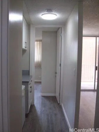 a view of a hallway with wooden floor