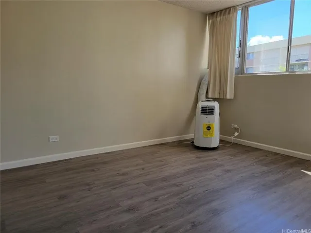 a view of a room with wooden floor and fence