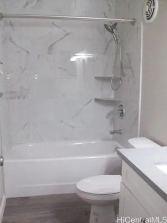 a bathroom with a toilet and a bath tub