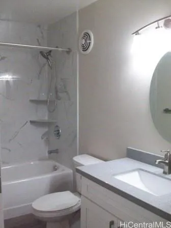 a bathroom with a granite countertop sink mirror toilet and bathtub