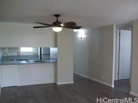 a kitchen with a sink a refrigerator and cabinets