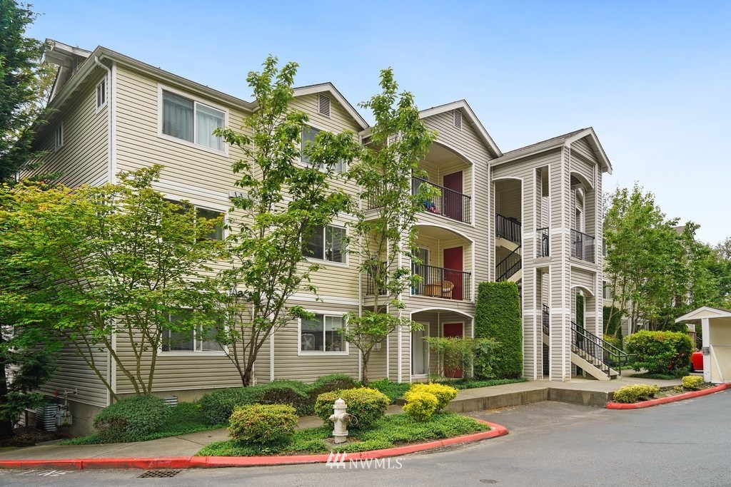 10709 Valley View Road, Unit A105 Bothell, WA 98011 - Photo 1 of 26 a front view of a house with a yard