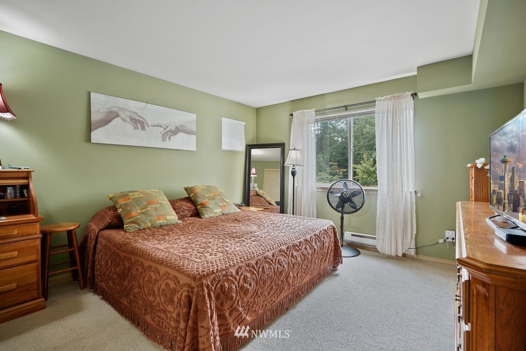 10709 Valley View Road, Unit A105 Bothell, WA 98011 - Photo 15 of 26 a bedroom with a bed and large window