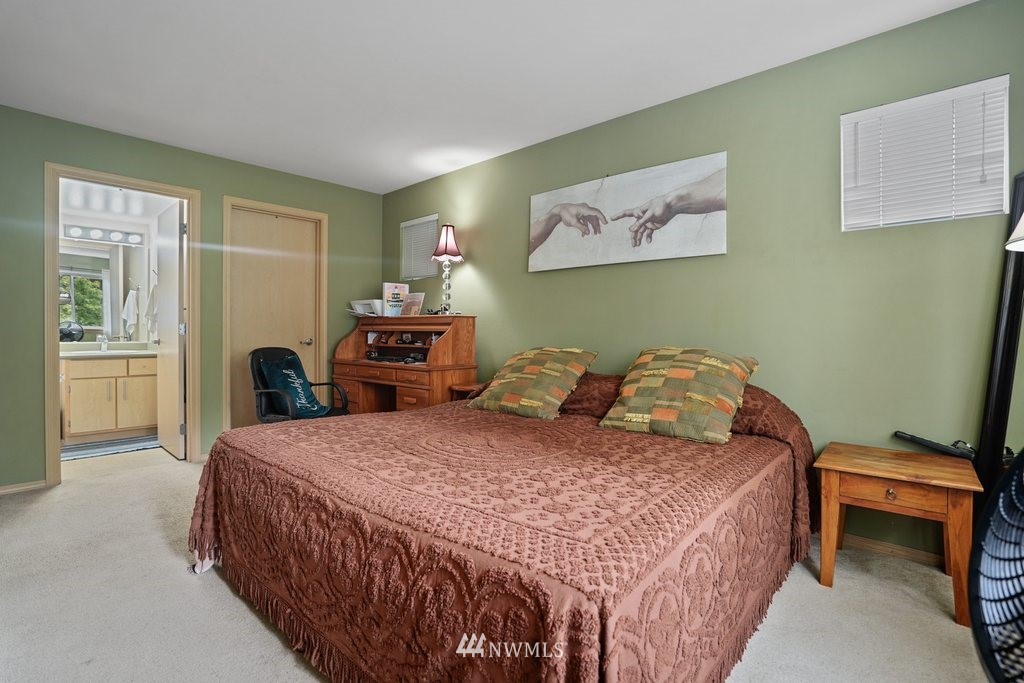 10709 Valley View Road, Unit A105 Bothell, WA 98011 - Photo 17 of 26 a bedroom with a bed and a desk