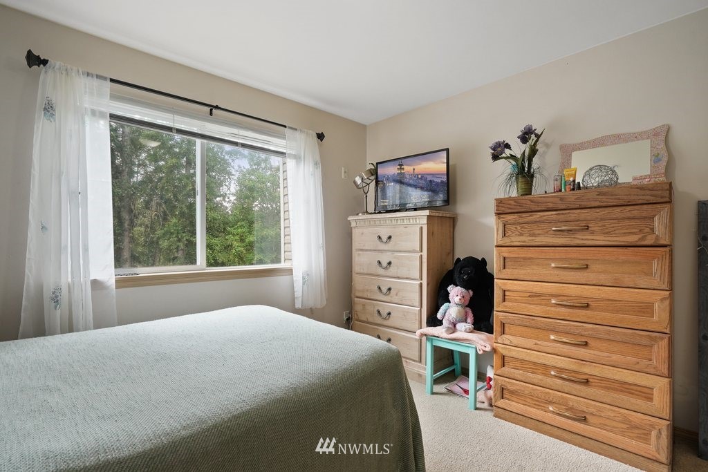 10709 Valley View Road, Unit A105 Bothell, WA 98011 - Photo 22 of 26 a bedroom with a bed and a window