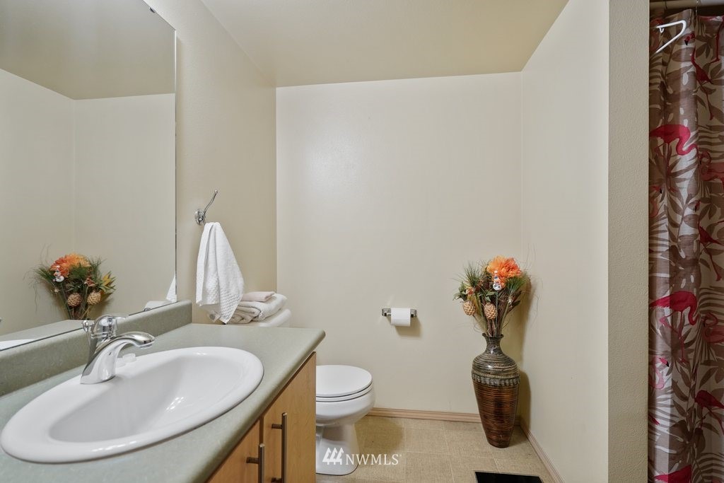 10709 Valley View Road, Unit A105 Bothell, WA 98011 - Photo 23 of 26 a bathroom with a toilet sink and mirror